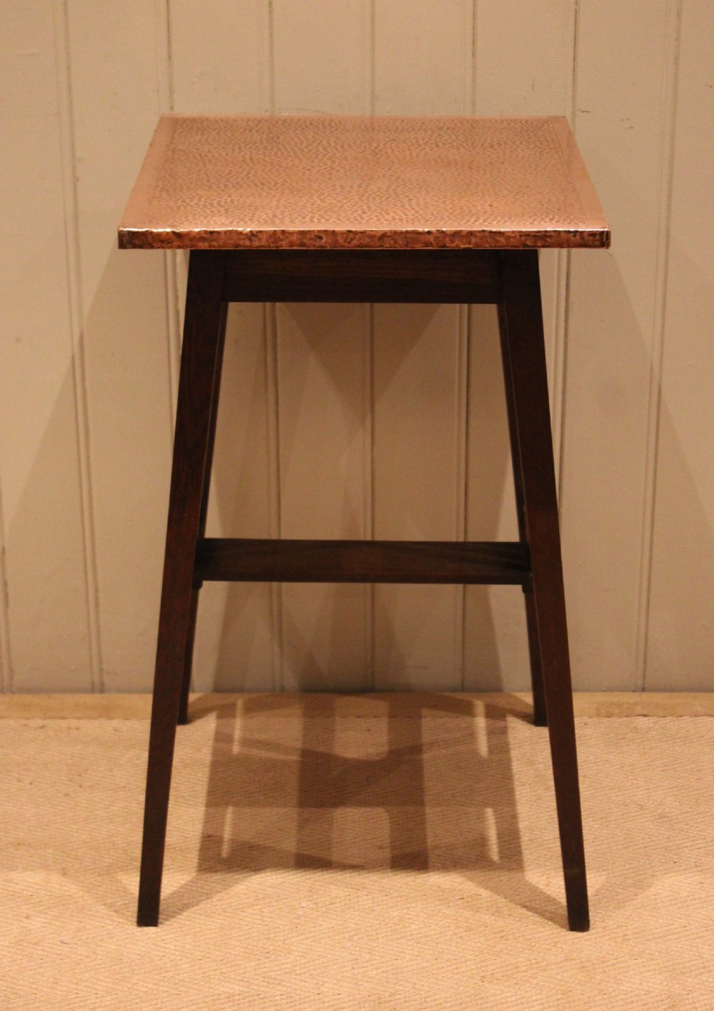 A square Arts and Crafts side table made of dark oak with a hand-hammered copper top, tapered legs, vertical slats, and cross stretchers. View VIII