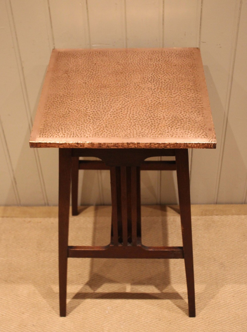 A square Arts and Crafts side table made of dark oak with a hand-hammered copper top, tapered legs, vertical slats, and cross stretchers. View XI