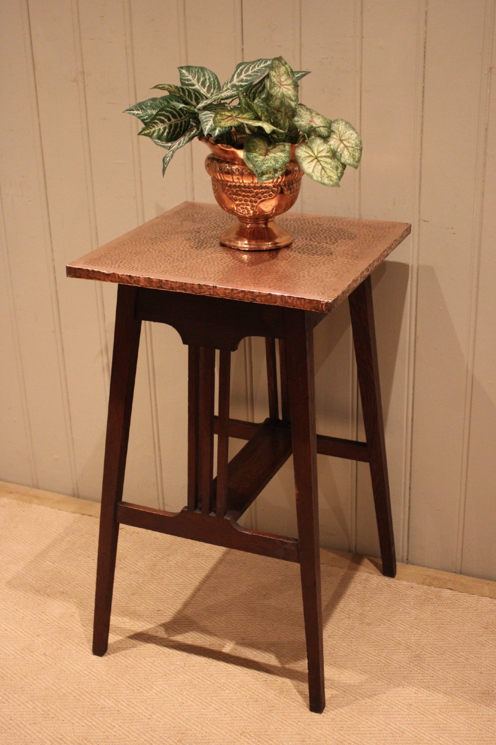 A square Arts and Crafts side table made of dark oak with a hand-hammered copper top, tapered legs, vertical slats, and cross stretchers. View XII