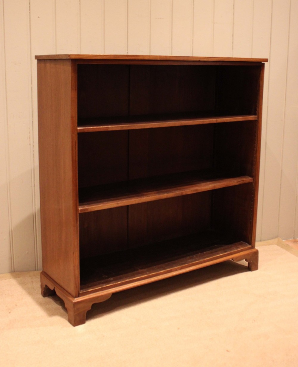 A late nineteenth-century mahogany open bookcase featuring three wide horizontal shelves and bracket feet. View II