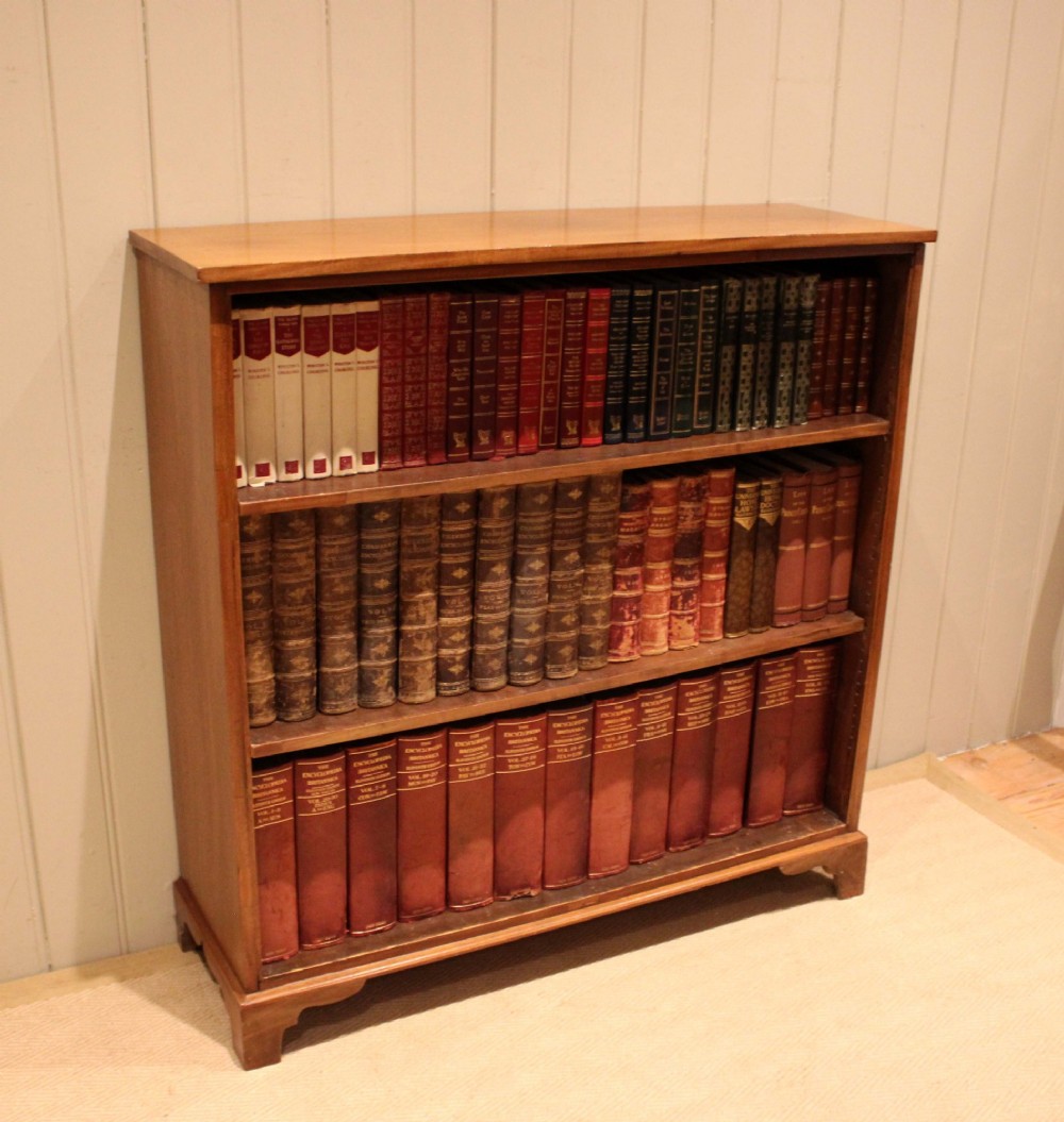 A late nineteenth-century mahogany open bookcase featuring three wide horizontal shelves and bracket feet. View V