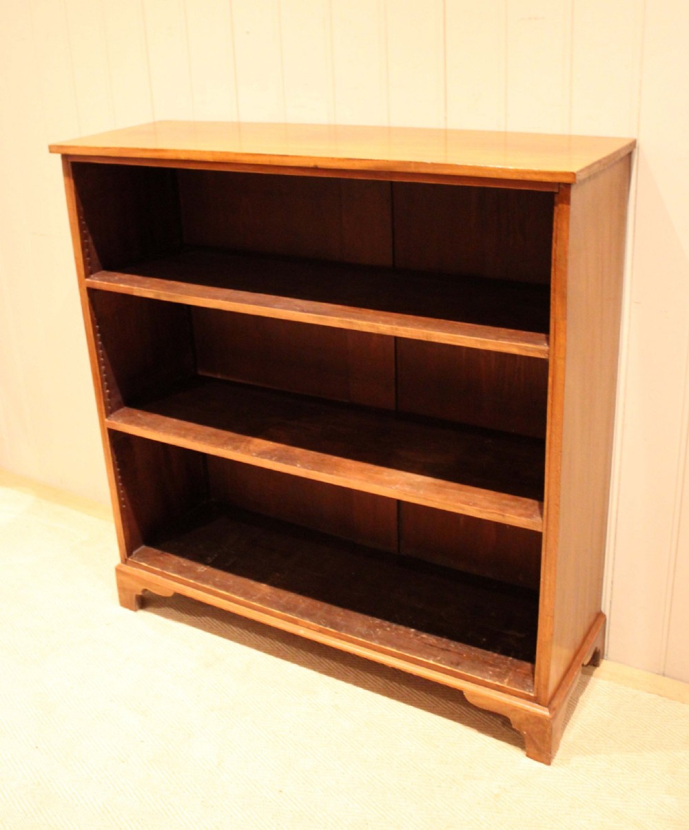 A late nineteenth-century mahogany open bookcase featuring three wide horizontal shelves and bracket feet. View VIII