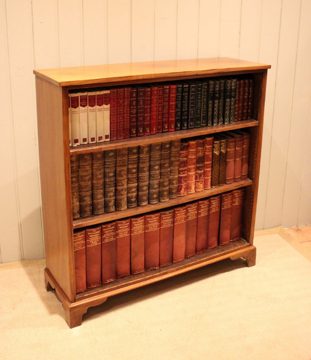 A late nineteenth-century mahogany open bookcase featuring three wide horizontal shelves and bracket feet. View XI