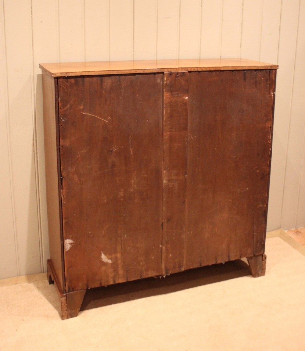A late nineteenth-century mahogany open bookcase featuring three wide horizontal shelves and bracket feet. View XII