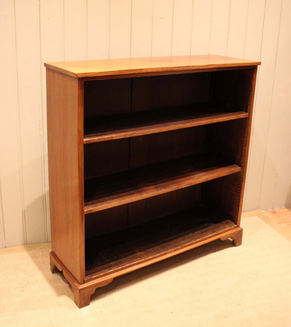 A late nineteenth-century mahogany open bookcase featuring three wide horizontal shelves and bracket feet. View XIII