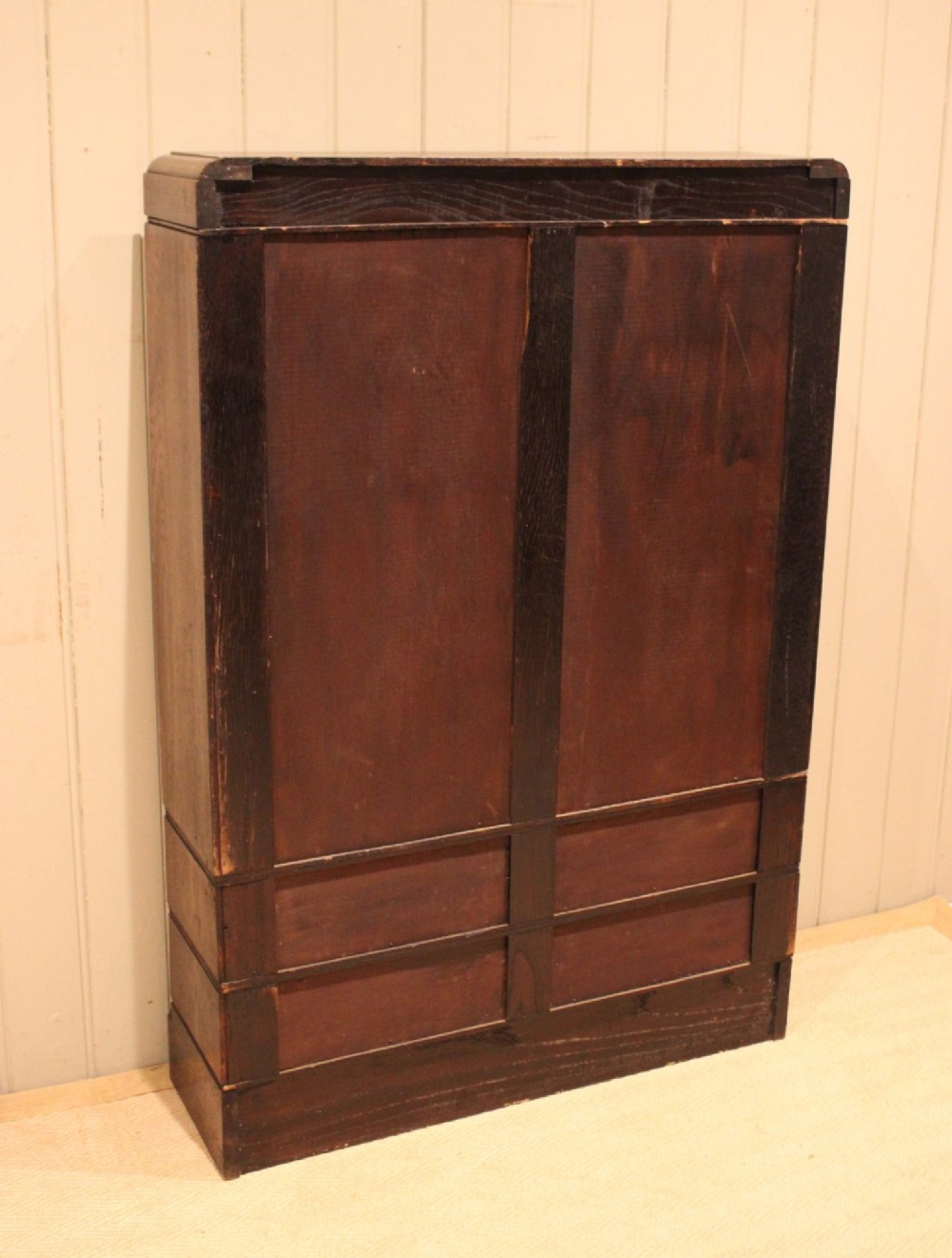 A medium brown oak glazed bookcase with two glass upper doors, carved egg-and-dart top moulding, and four drawers with brass handles. View XII