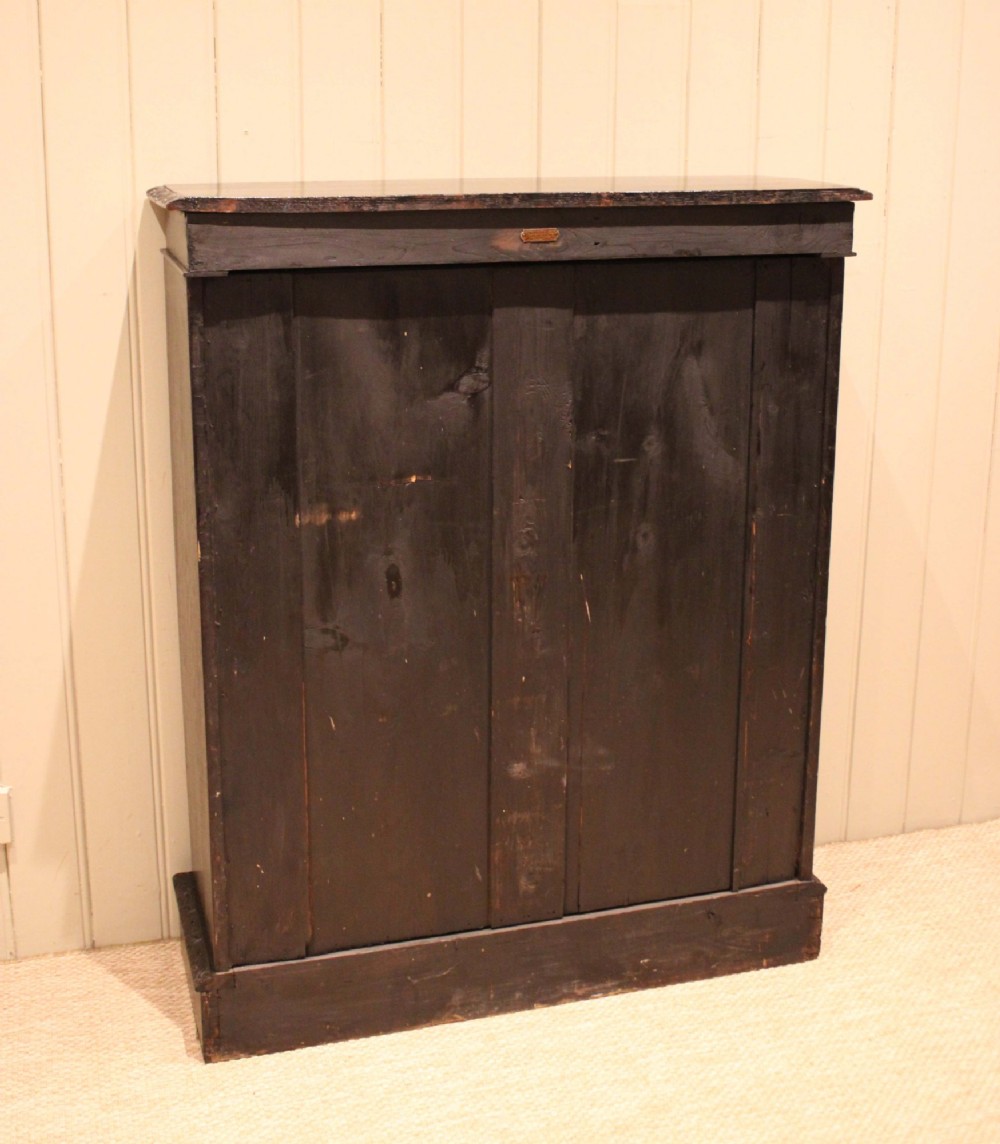 A mid-Victorian dark oak open bookcase featuring hand-carved leaf mouldings and three open shelves filled with antique books. View XII