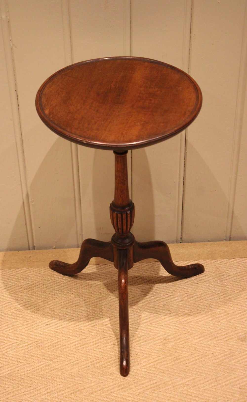 A mahogany wine table featuring a circular dished top supported by a turned reeded pedestal on three splayed cabriole legs. View III