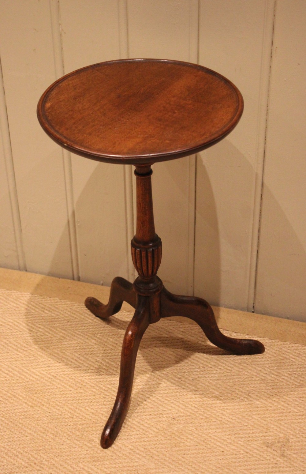 A mahogany wine table featuring a circular dished top supported by a turned reeded pedestal on three splayed cabriole legs. View VII