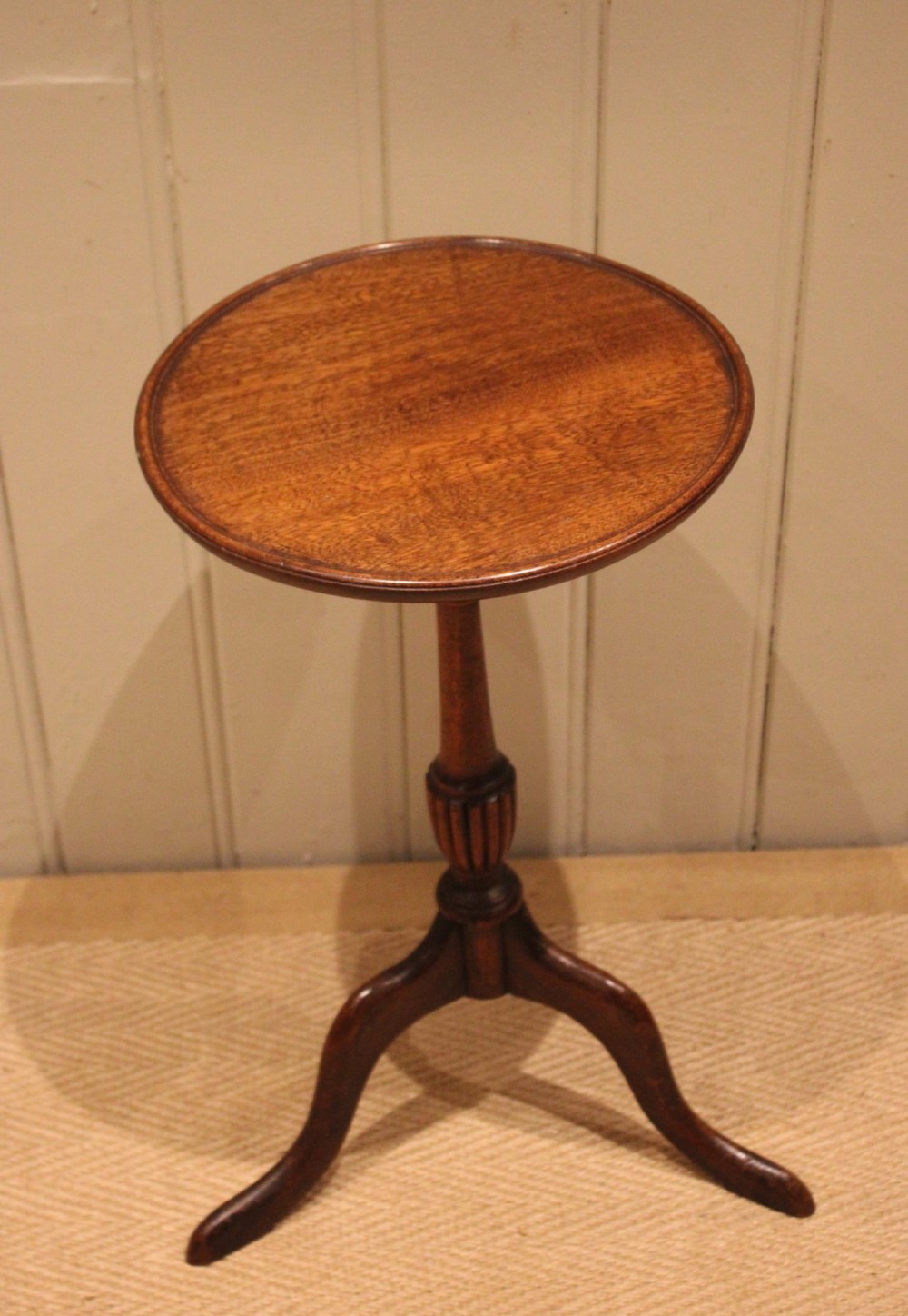 A mahogany wine table featuring a circular dished top supported by a turned reeded pedestal on three splayed cabriole legs. View IX