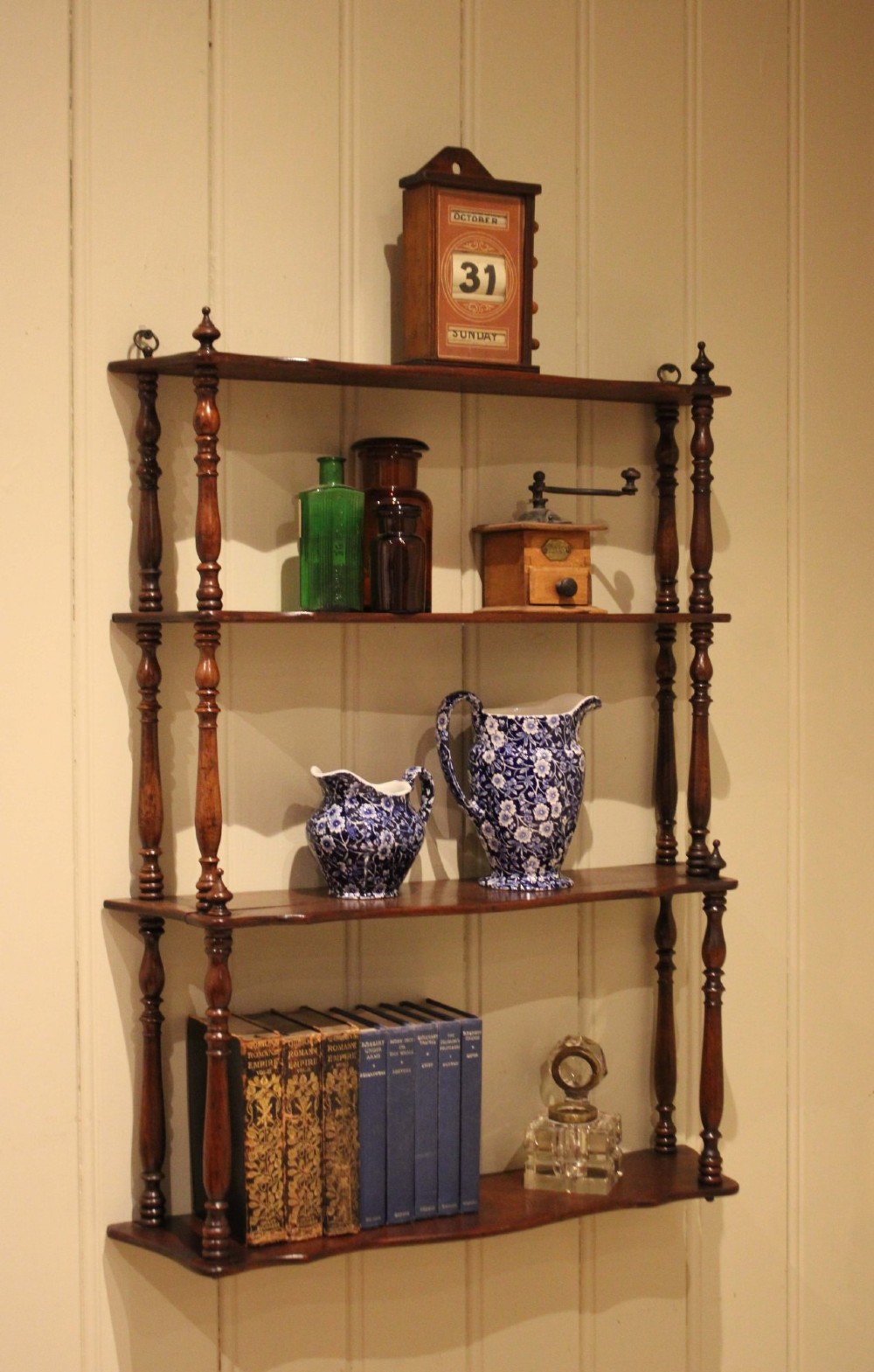 A four-tier late nineteenth-century French mahogany wall shelf unit with turned spindle supports and shaped shelf fronts. View II