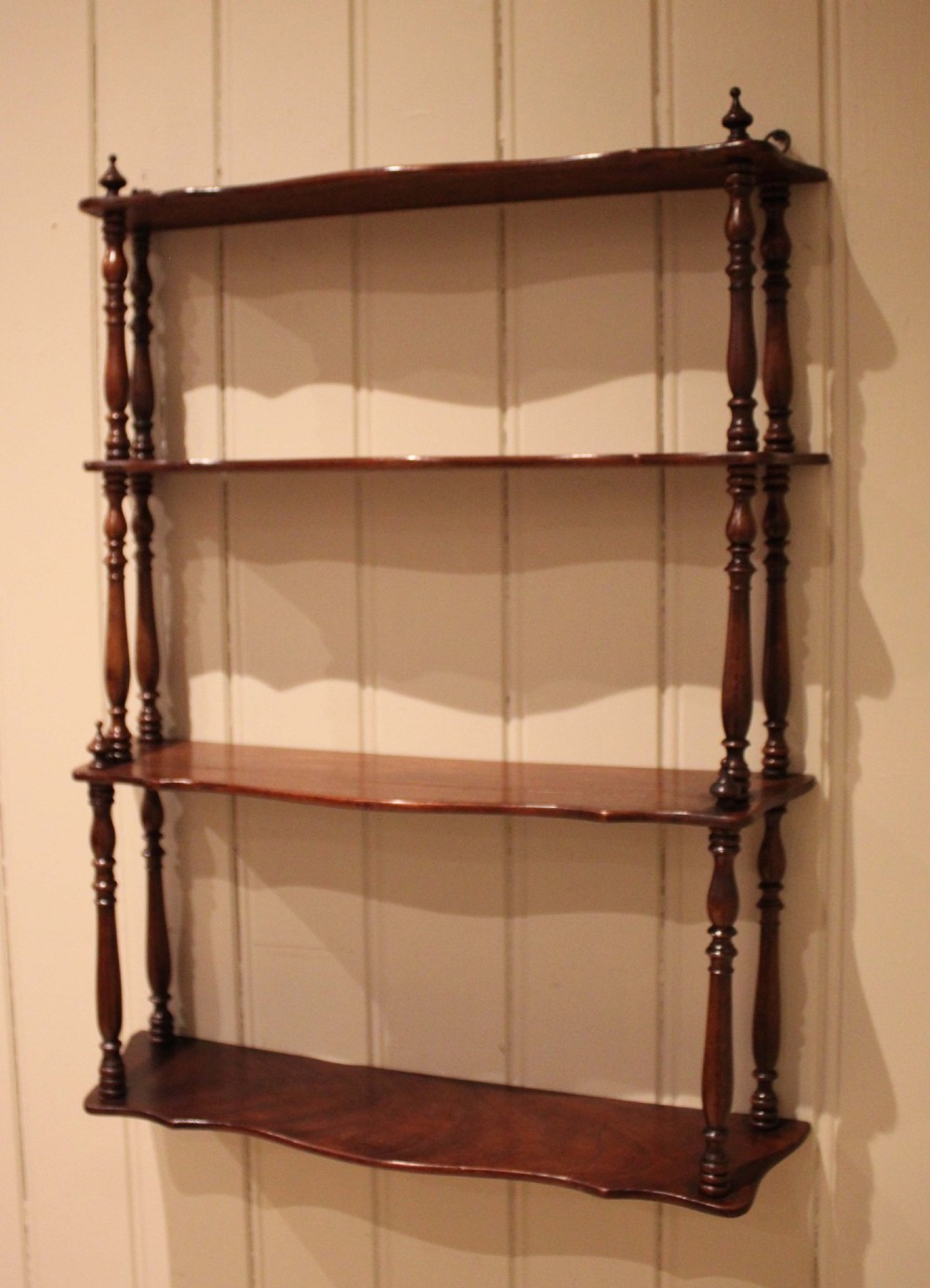 A four-tier late nineteenth-century French mahogany wall shelf unit with turned spindle supports and shaped shelf fronts. View IV