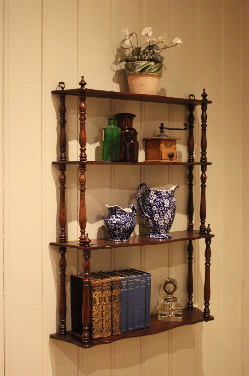 A four-tier late nineteenth-century French mahogany wall shelf unit with turned spindle supports and shaped shelf fronts. View XI