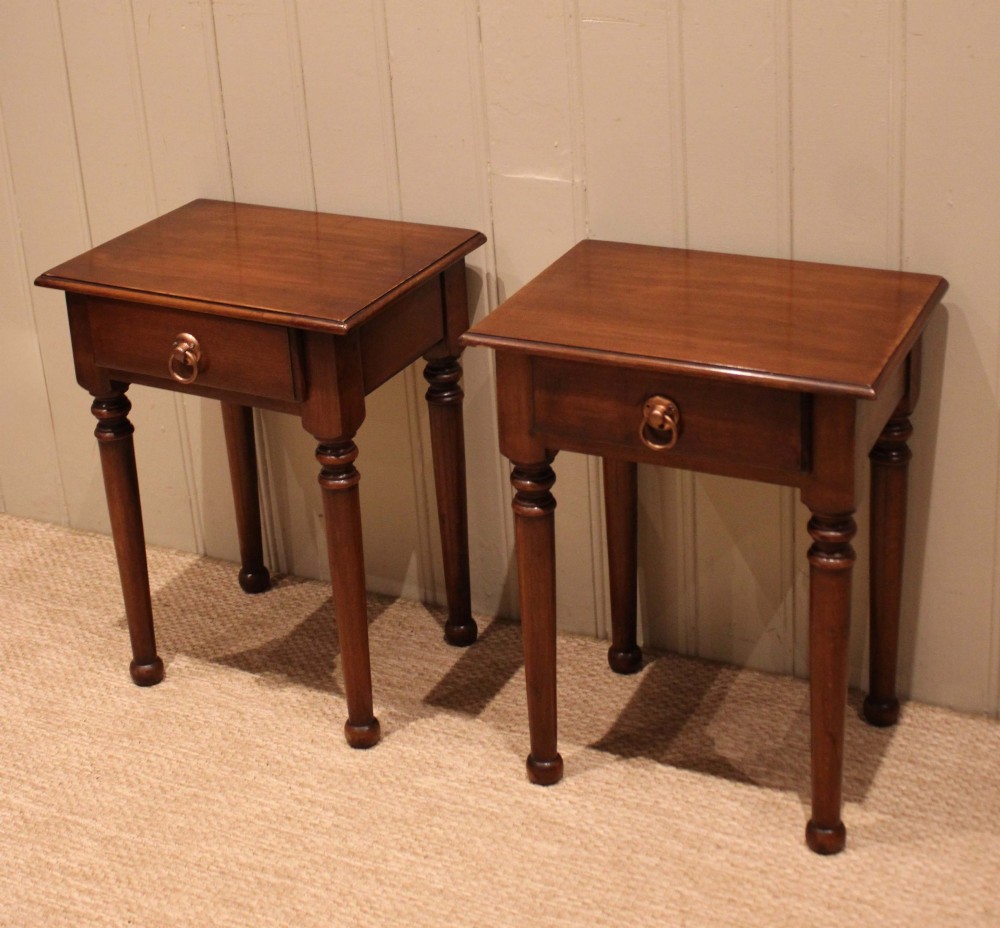 A pair of warm brown French cherry wood bedside tables featuring single drawers with brass ring pulls and slender turned legs. View II