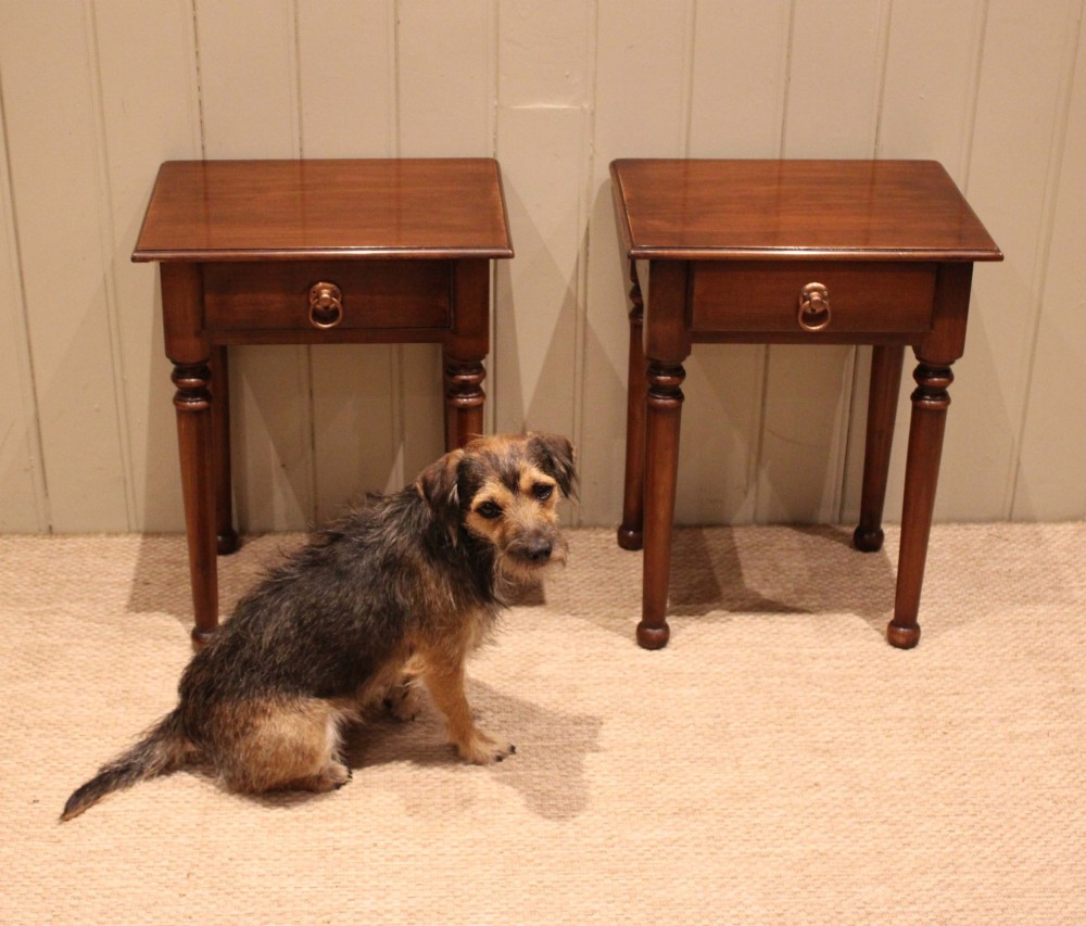 A pair of warm brown French cherry wood bedside tables featuring single drawers with brass ring pulls and slender turned legs. View V