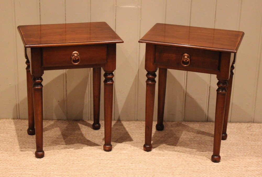 A pair of warm brown French cherry wood bedside tables featuring single drawers with brass ring pulls and slender turned legs. View VIII