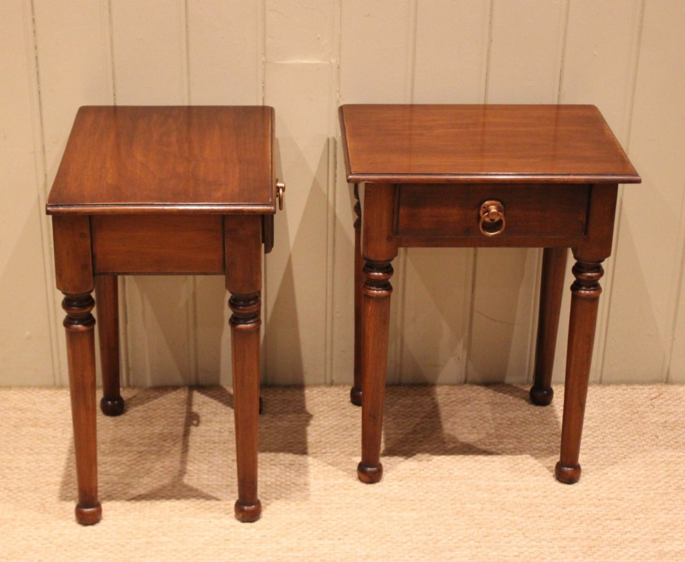 A pair of warm brown French cherry wood bedside tables featuring single drawers with brass ring pulls and slender turned legs. View XII