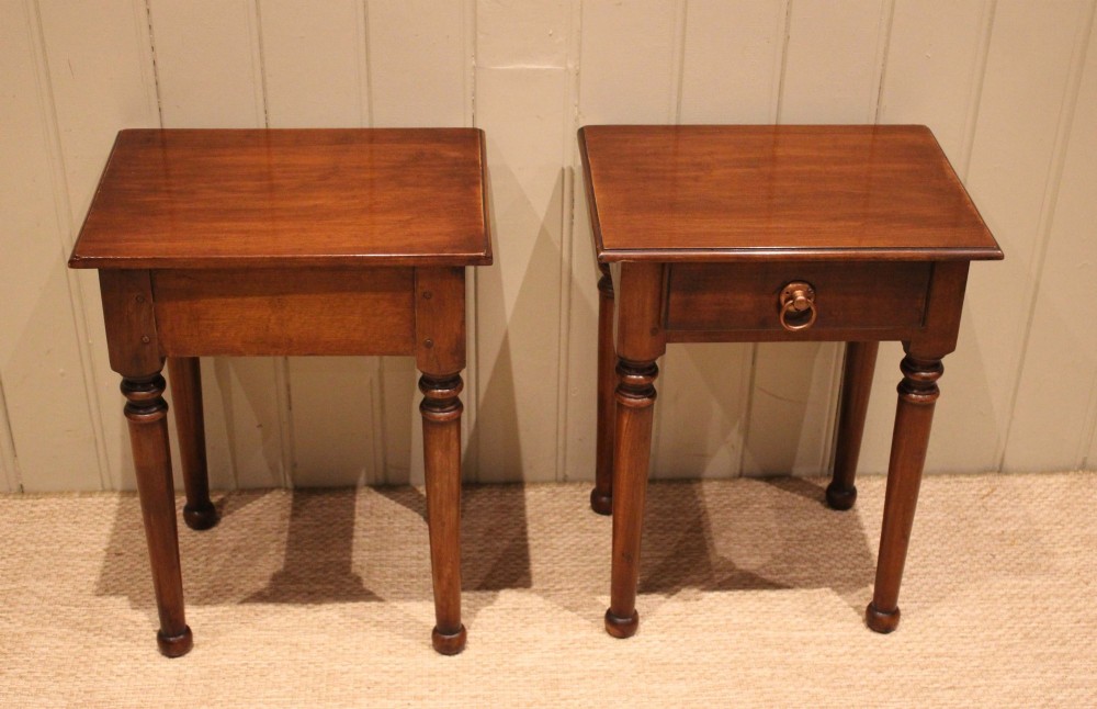 A pair of warm brown French cherry wood bedside tables featuring single drawers with brass ring pulls and slender turned legs. View XIII