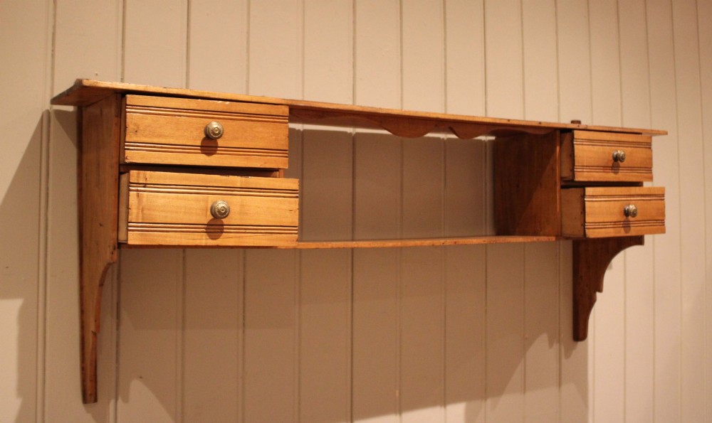 A French poplar wooden wall shelf featuring four side drawers, a central open compartment, and carved lower wall brackets. View VIII