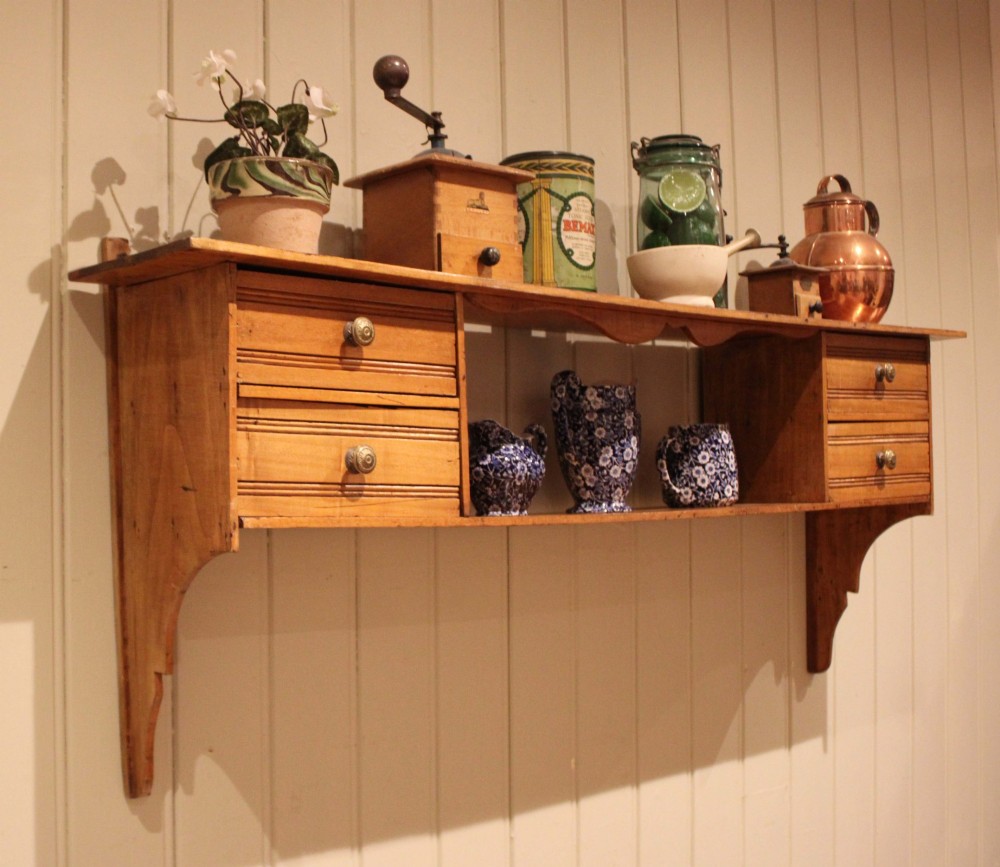 A French poplar wooden wall shelf featuring four side drawers, a central open compartment, and carved lower wall brackets. View XI