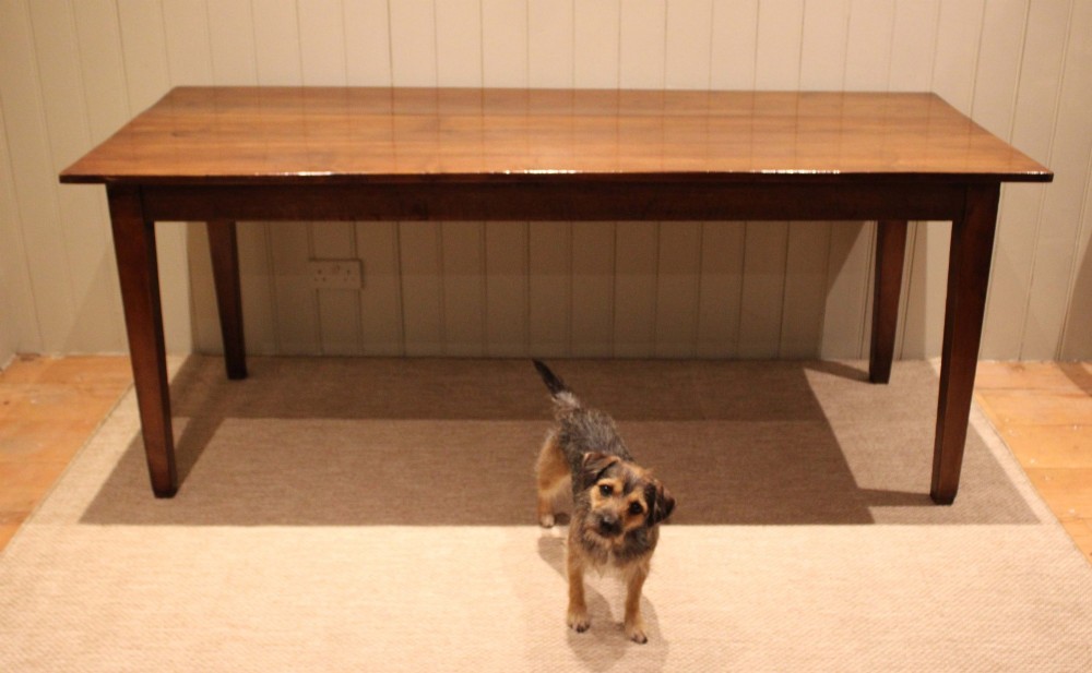 A large rectangular wooden farmhouse table made of chestnut and oak with a polished plank top and simple tapered square legs. View IV