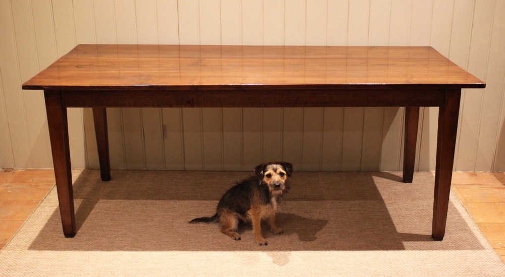 A large rectangular wooden farmhouse table made of chestnut and oak with a polished plank top and simple tapered square legs. View X