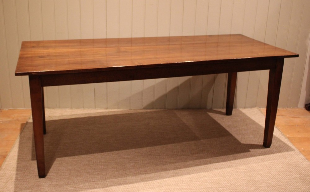 A large rectangular wooden farmhouse table made of chestnut and oak with a polished plank top and simple tapered square legs. View XI