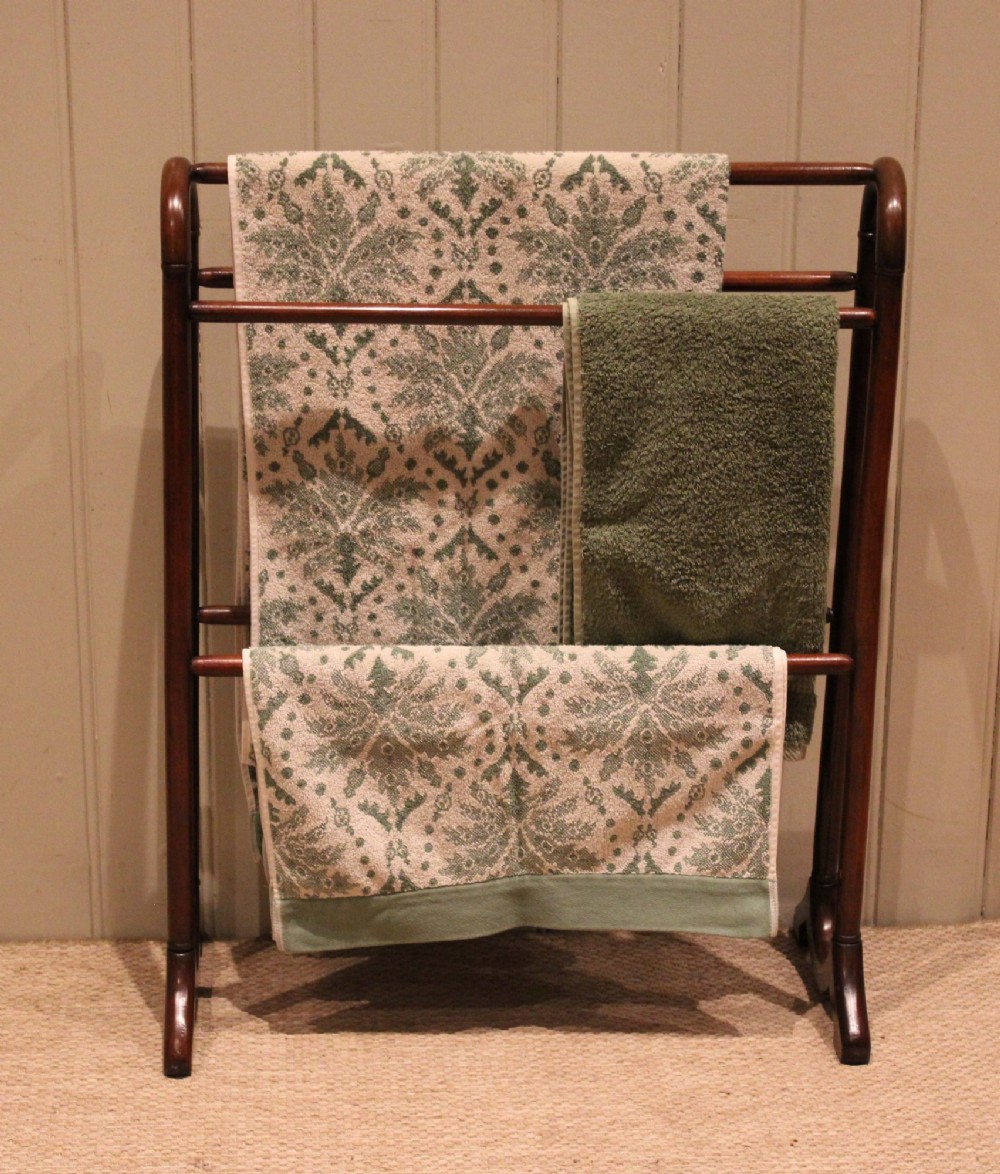A late 19th-century mahogany freestanding towel rail featuring rounded upright arches, multiple horizontal crossbars, and curved trestle feet. View II