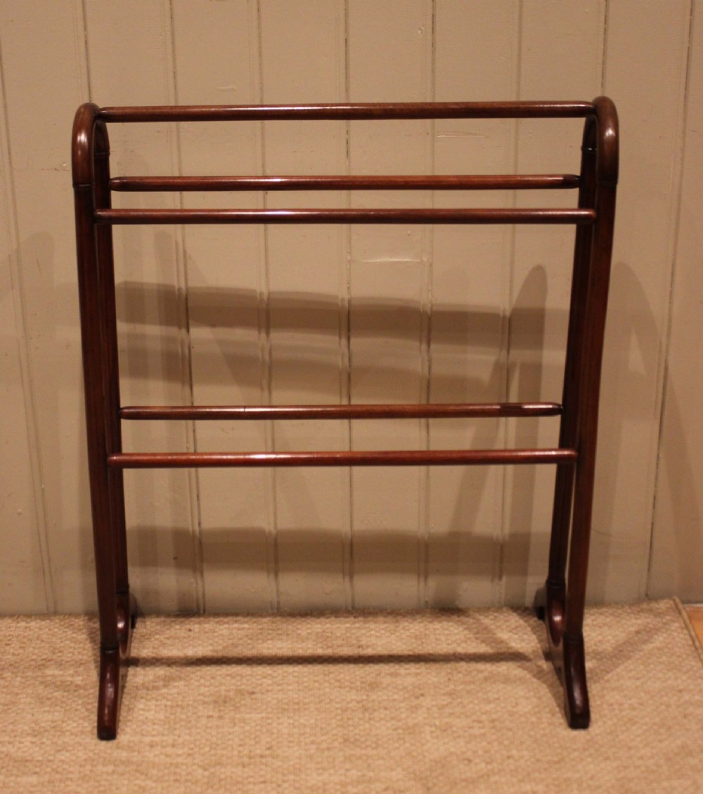 A late 19th-century mahogany freestanding towel rail featuring rounded upright arches, multiple horizontal crossbars, and curved trestle feet. View III