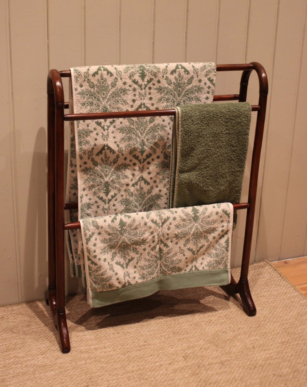 A late 19th-century mahogany freestanding towel rail featuring rounded upright arches, multiple horizontal crossbars, and curved trestle feet. View IV