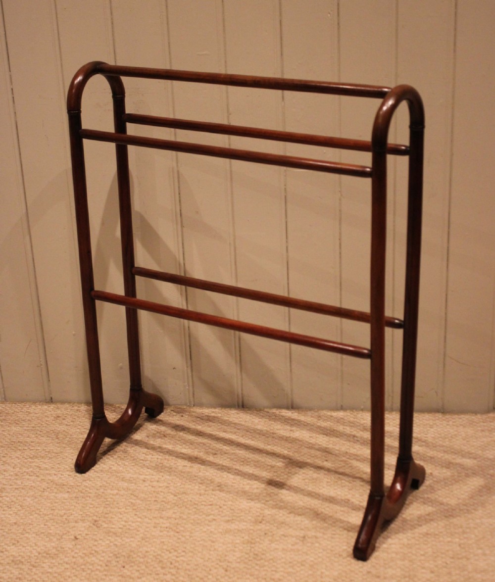 A late 19th-century mahogany freestanding towel rail featuring rounded upright arches, multiple horizontal crossbars, and curved trestle feet. View V
