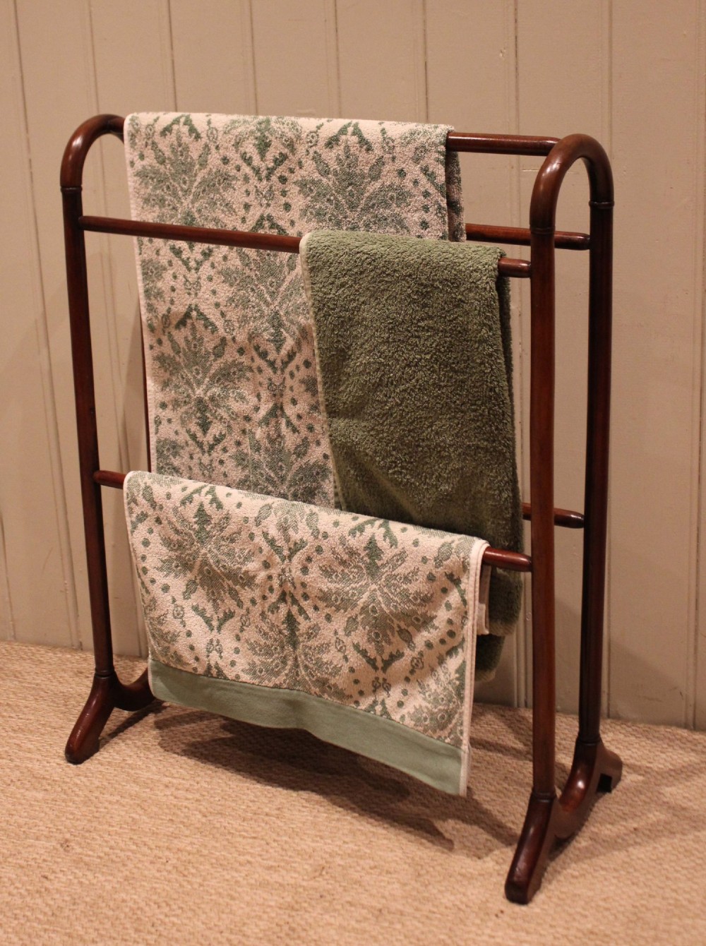 A late 19th-century mahogany freestanding towel rail featuring rounded upright arches, multiple horizontal crossbars, and curved trestle feet. View VI