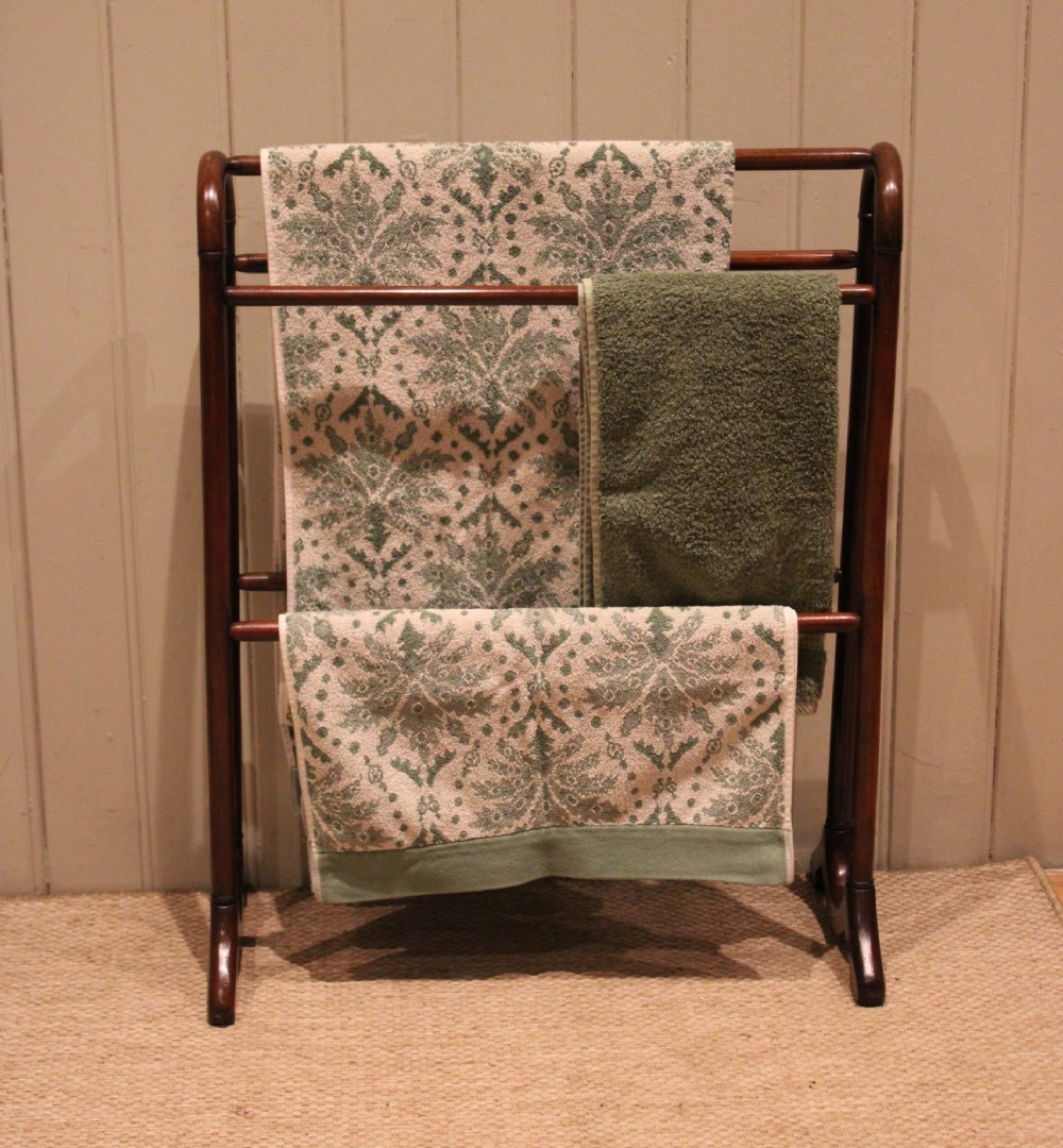 A late 19th-century mahogany freestanding towel rail featuring rounded upright arches, multiple horizontal crossbars, and curved trestle feet. View VIII