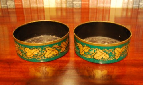 Pair of Early 19th. Century Toleware Decanter Coasters with Gilt Vine Decoration on a Green Ground.