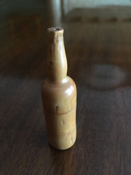 Miniature Wooden Bottle Shaped Box Containing Three Small Bone Dice.