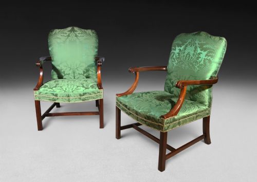 fig 1. A pair of Chippendale period Gainsborough armchairs with carved mahogany frames, scrolled arms, and green damask upholstery trimmed with brass studs.