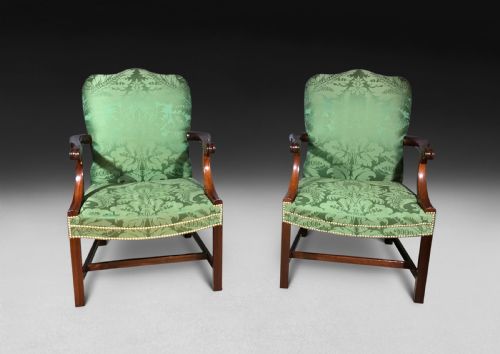 fig 2. A pair of Chippendale period Gainsborough armchairs with carved mahogany frames, scrolled arms, and green damask upholstery trimmed with brass studs.