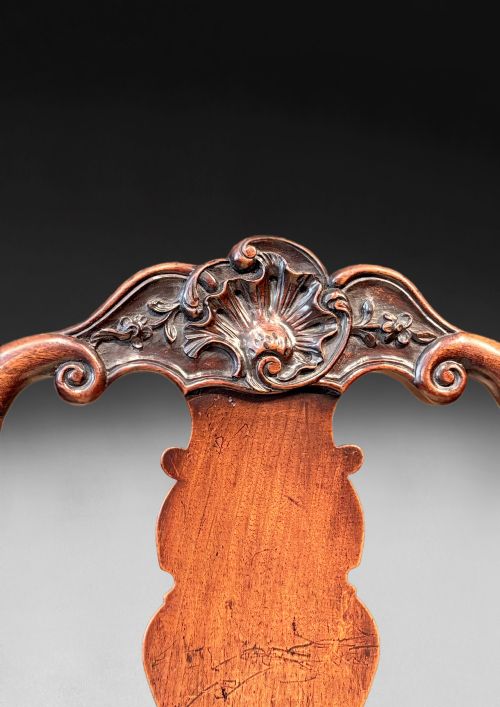fig 4. A pair of antique George I walnut side chairs featuring carved cresting rails, vase-shaped back splats, floral upholstered drop-in seats, and cabriole front legs.