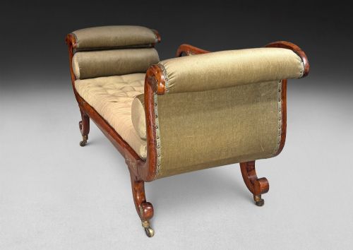 fig 4. Regency simulated rosewood chaise longue with brass inlay, featuring asymmetrical scroll ends, turned brass-castor legs, olive green button-tufted upholstery, and matching bolster cushions.