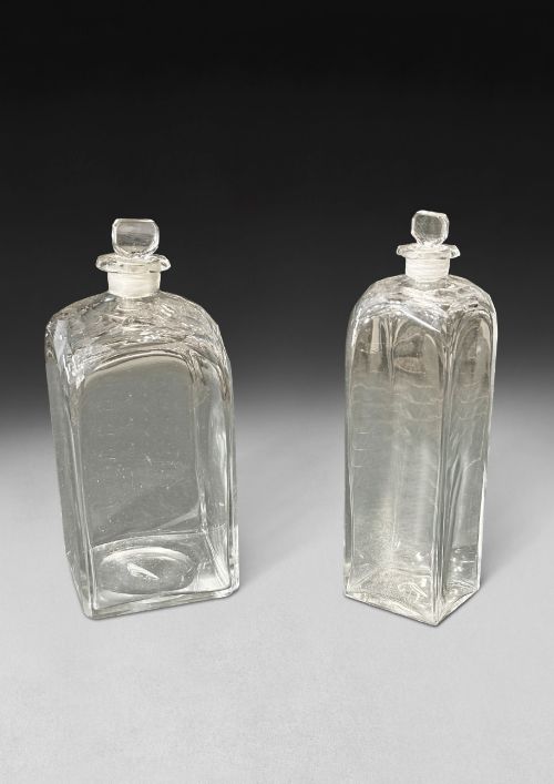 fig 1. An open George III mahogany decanter chest displaying fitted glass decanters, internal compartments, velvet lid lining, and brass hardware.