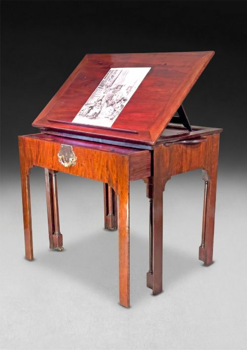 fig 1. A George II mahogany architects table featuring an adjustable ratcheted writing surface, candle slides, pull-out drawer mechanism, and square legs.