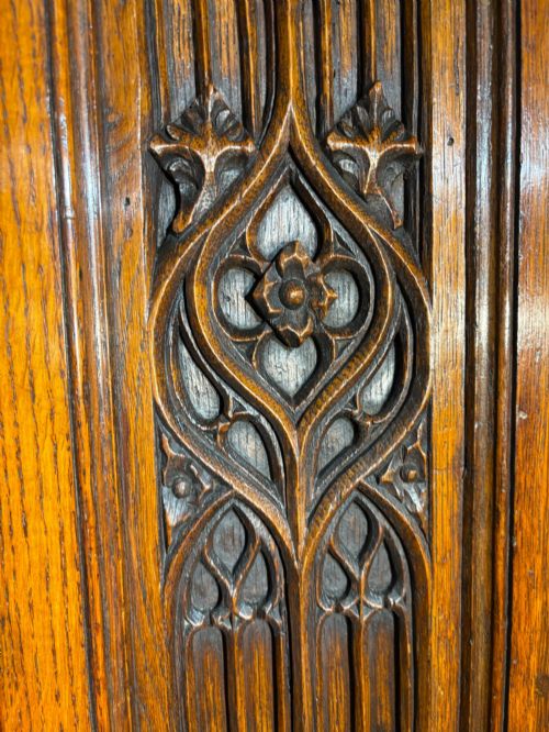 fig 2. A mid-19th-century carved oak tabletop cabinet featuring double doors and side panels decorated with Gothic Revival tracery carvings.