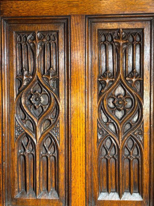 fig 3. A mid-19th-century carved oak tabletop cabinet featuring double doors and side panels decorated with Gothic Revival tracery carvings.
