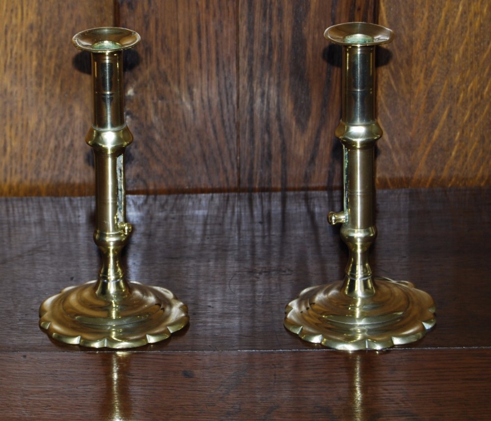 Pair of early 18th. Century Brass Petal Based Candlesticks with ejector slides