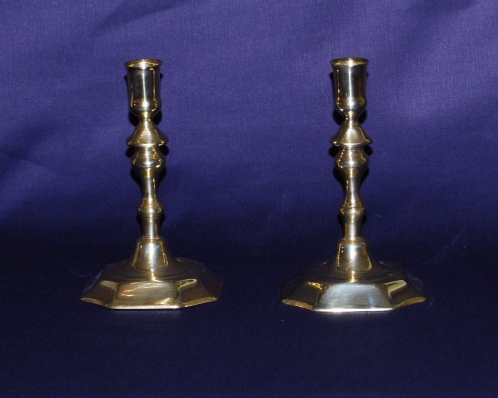 A pair of early 18th. century Brass Candlesticks with an  octagonal foot