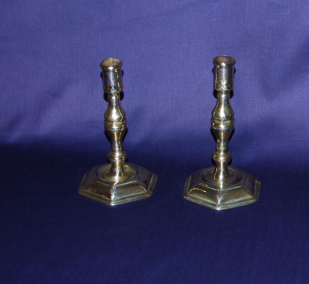 A pair of early 18th. century Brass Candlesticks with a hexagonal foot 