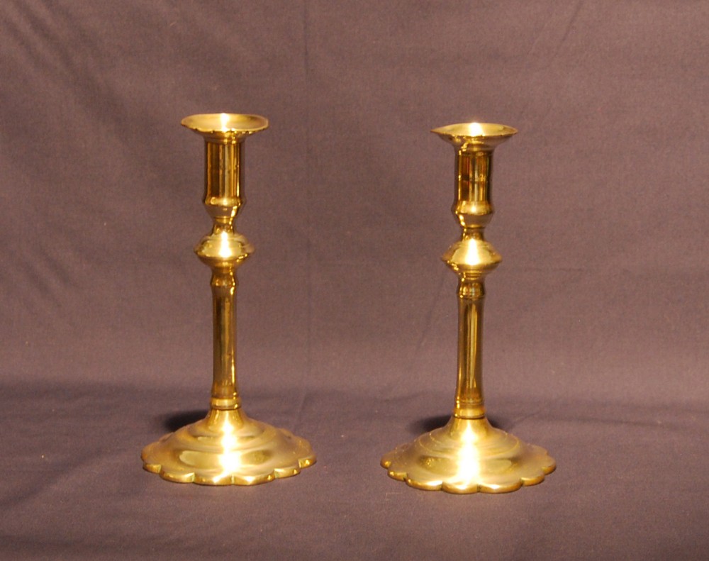 Pair of George II petal based Brass Candlesticks 