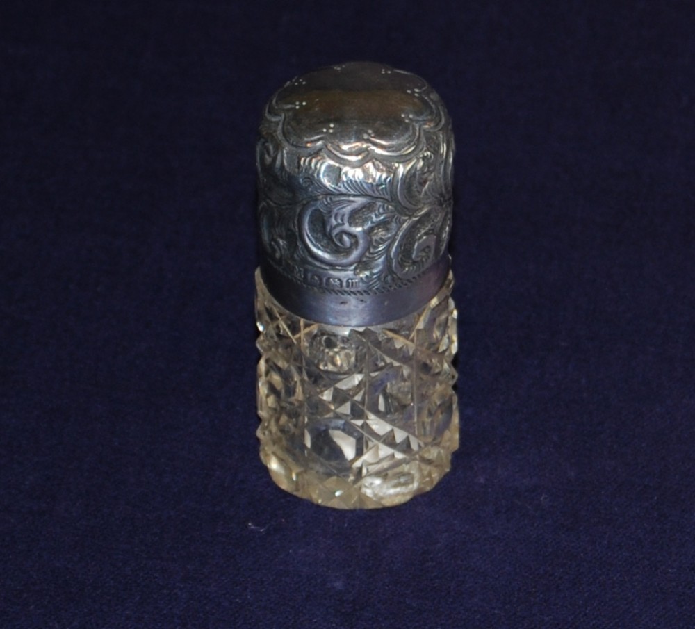 A silver topped hobnail cut glass smelling salt.
