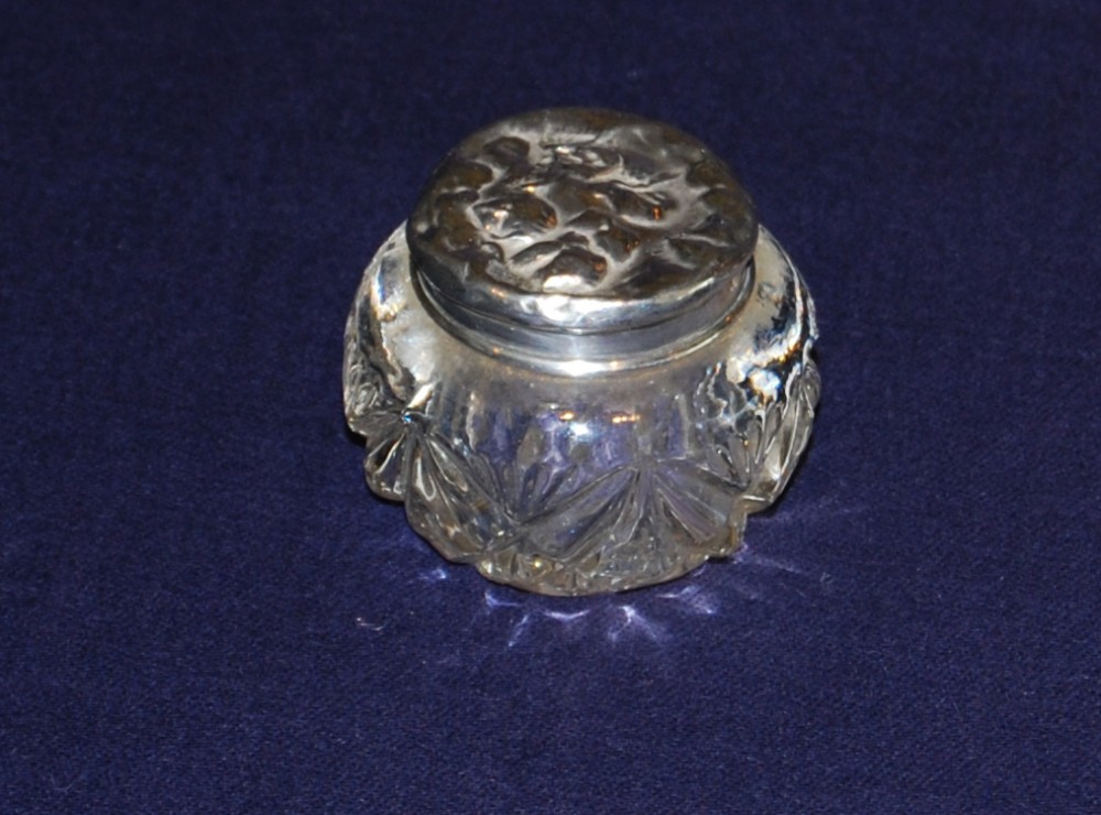 A silver mounted cut glass Jar.