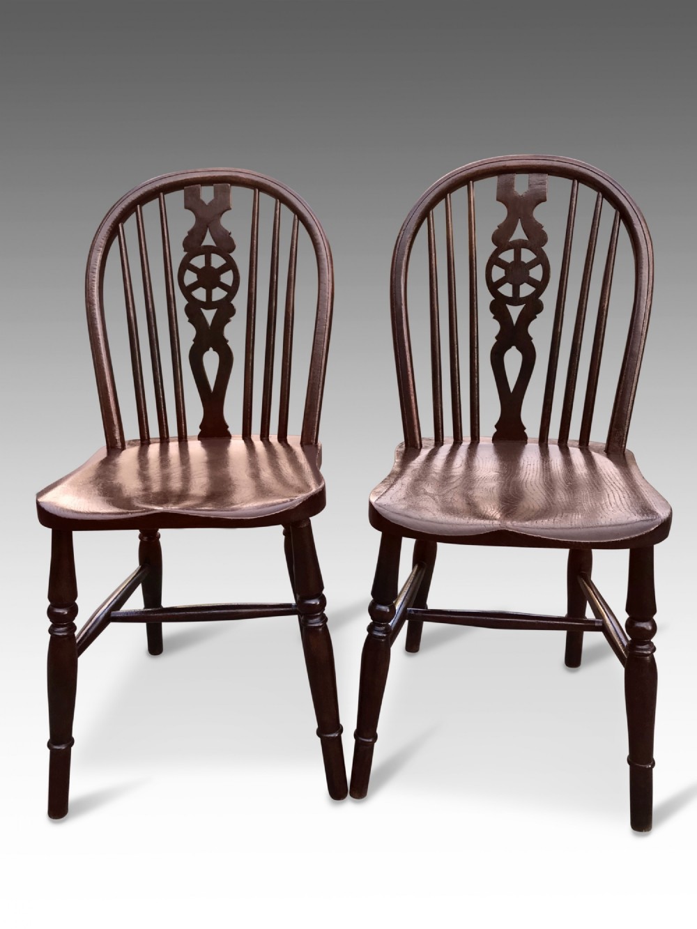 A pair of Victorian Elm and Oak Low Wheel Back Windsor side chairs